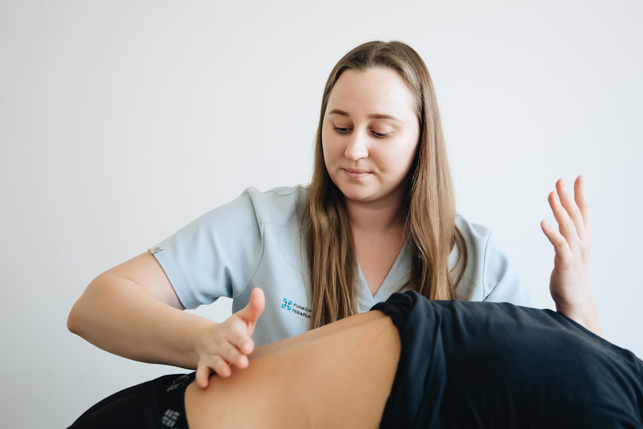 A physiotherapist performing back therapy on a client to relieve tension and improve spinal health.